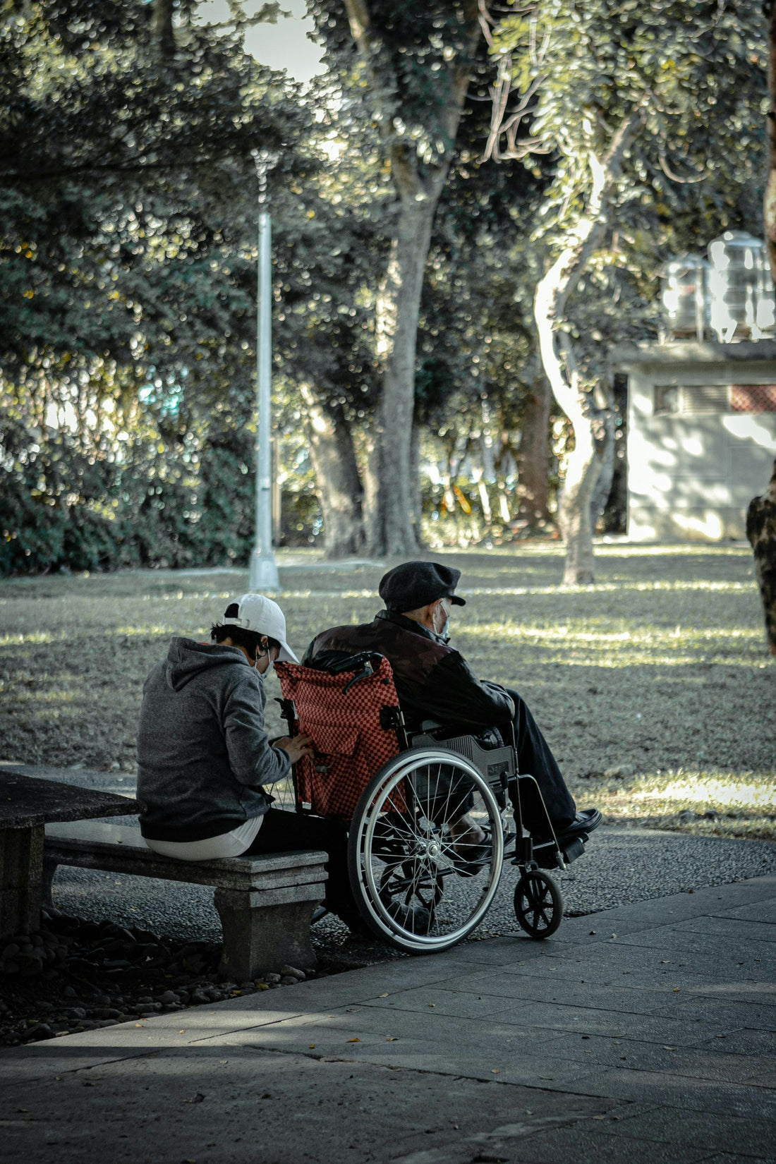 two people sitting in a park