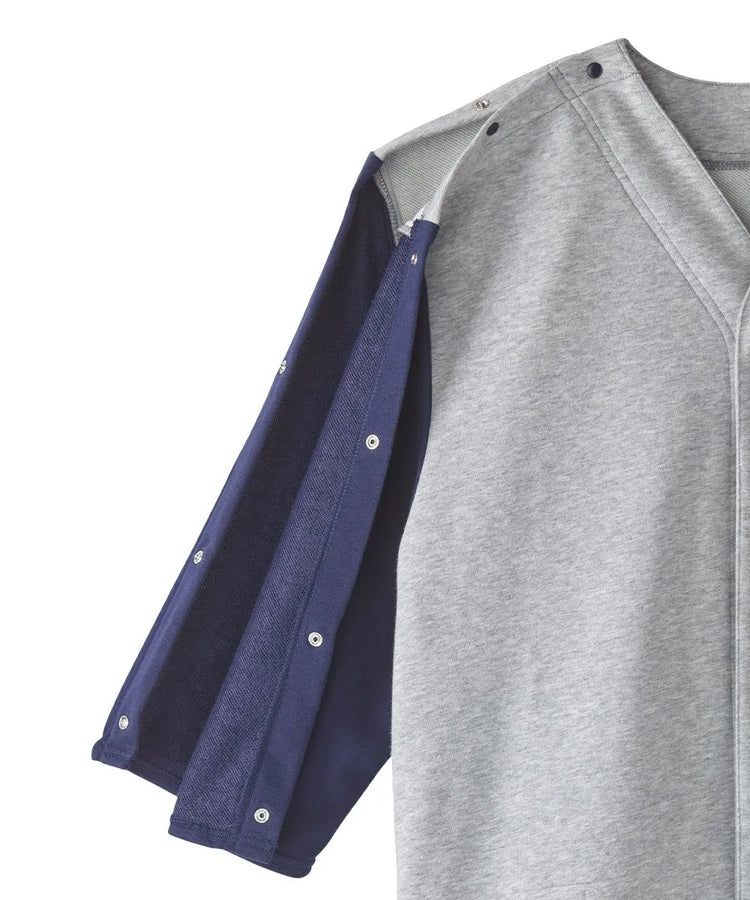 Close-up of the sleeve snap closures on June Adaptive Unisex Adaptive Shirt in grey with navy sleeves, demonstrating the easy-use design.