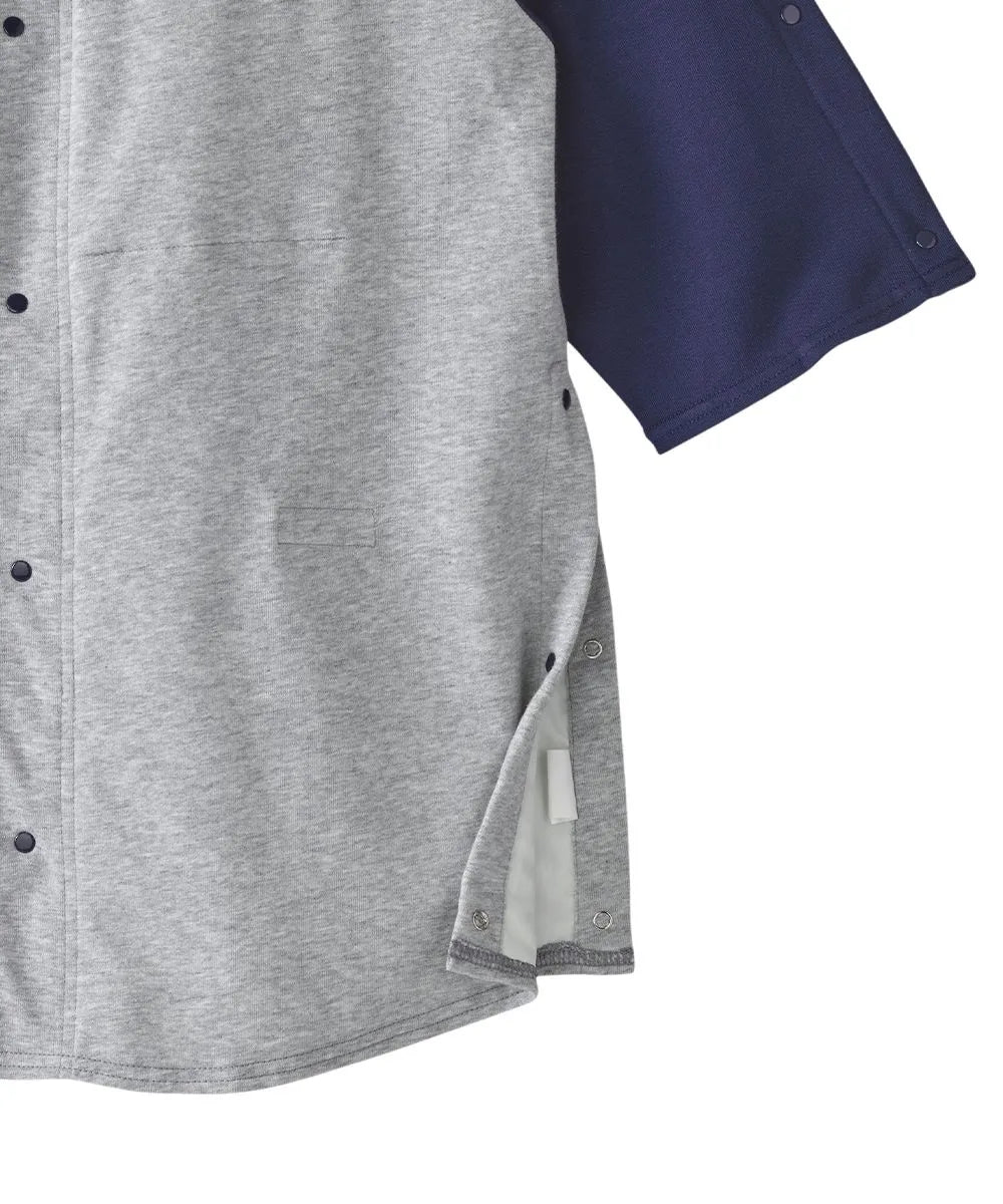 Detailed view of the side snap closures on June Adaptive Unisex Adaptive Shirt in grey with navy sleeves, showing the accessible design features